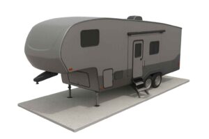 5th Wheel Camper Gray fifth wheel trailer on a cement slab, featuring multiple windows, a door with steps, and dual axles.