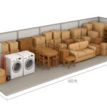 A storage unit filled with stacked boxes, a refrigerator, washing machines, a sofa, tables, chairs, and assorted furniture. The dimensions are 8 feet high, 8 feet wide, and 40 feet long.
