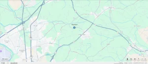 A digital map showing the area around Basswood, near highways and green spaces, with roads, towns, and water features labeled. A marker pinpoints the location of Basswood.