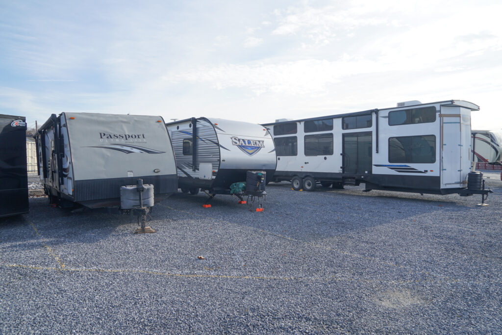 RVs and travel trailers parked on a gravel parking area at SteelSafe Hamburg, Pennsylvania.