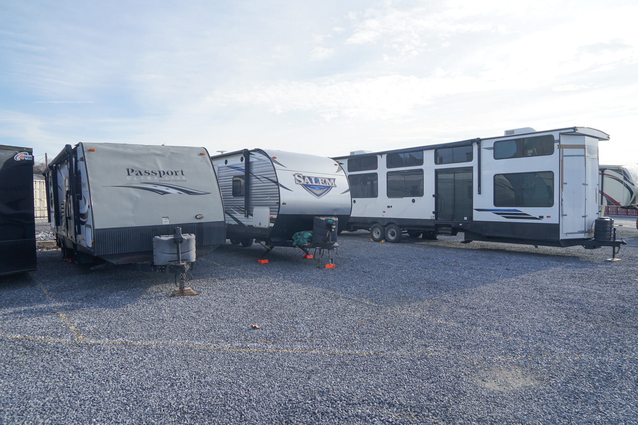 RVs and travel trailers parked on a gravel parking area at SteelSafe Hamburg, Pennsylvania.