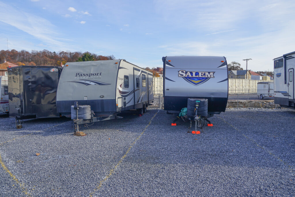 Travel trailers parked in a gravel parking area at SteelSafe Hamburg, Pennsylvania.